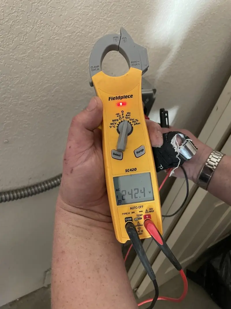 Voltage testing with clamp meter during Recessed Lighting Installation in Hayesville